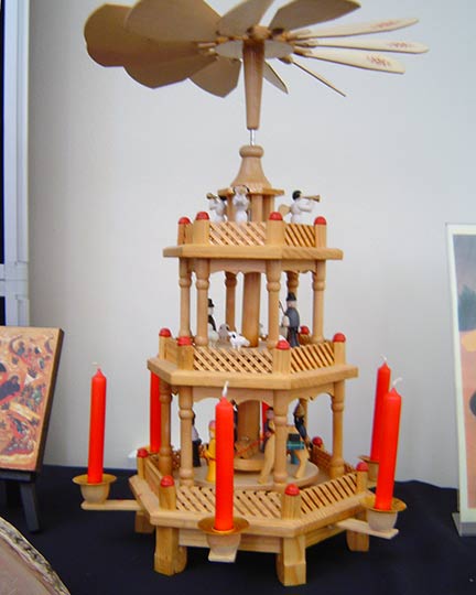 A three tier model with moving parts powered by hot air from the candles