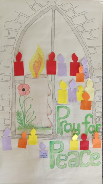 large poster with prayer candles added